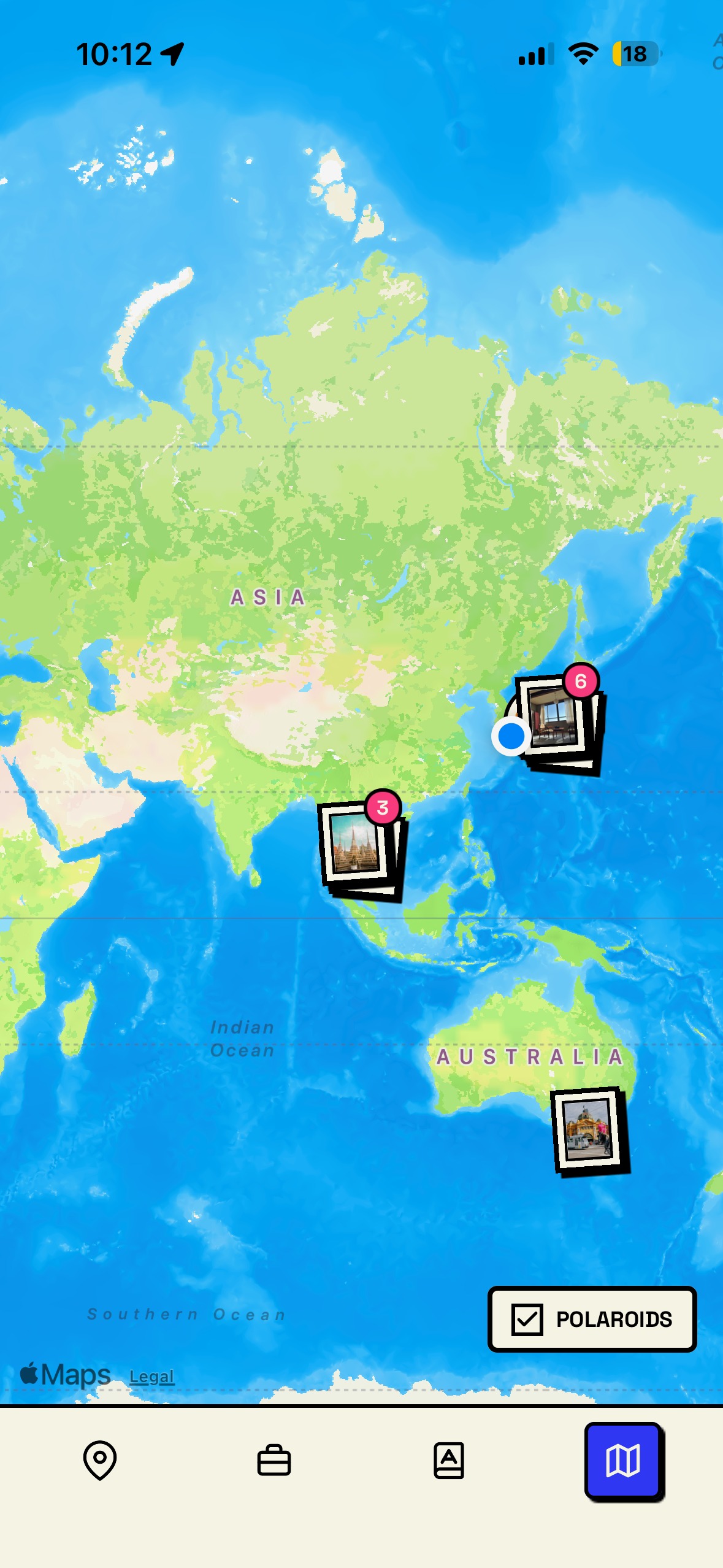 World map view showing polaroid memories across different countries